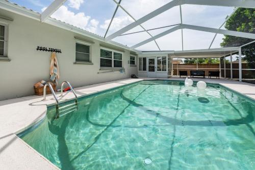 a large swimming pool with a glass roof at Peacock Pool House & Hot Tub Clearwater beaches in Clearwater