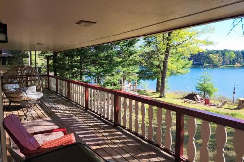 a balcony with a large view of a lake at Hooked on Johnson in Arbor Vitae