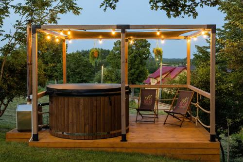 a wooden deck with a gazebo with a drum at Forrest Houses Bartosze in Bartosze