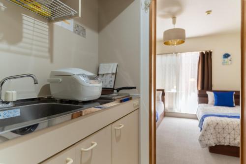 a kitchen with a sink and a mixer on a counter at 両国駅前 in Tokyo