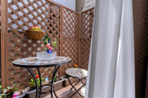 a small table on a balcony with a fence at 両国駅前 in Tokyo