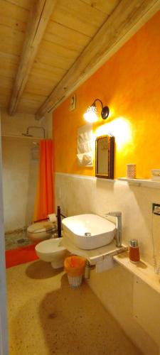 a bathroom with two toilets and a sink at Dimora Maltese in Morciano di Leuca