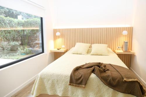a bedroom with a bed with a large window at Hotel Colina Inn Escazu in San Rafael