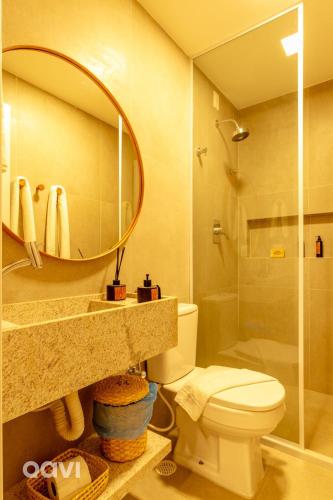 a bathroom with a sink and a toilet and a mirror at Naluum Residence Alto Padrão em Milagres By Qavi in Passo de Camarajibe