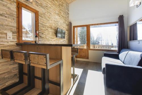 a living room with a bar in a house at Les Chalets Autrichiens - Megève in Megève