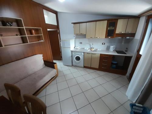 a small kitchen with a sink and a washing machine at Aleksi&Eli in Shkodër