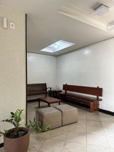 a waiting room with benches and a table and a window at Panorama Hotel in Belém