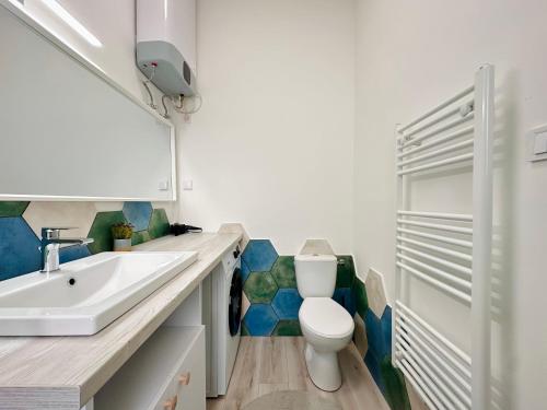 a bathroom with a sink and a toilet at Colorful Condo by the Danube ---FREE PARKING--- in Budapest