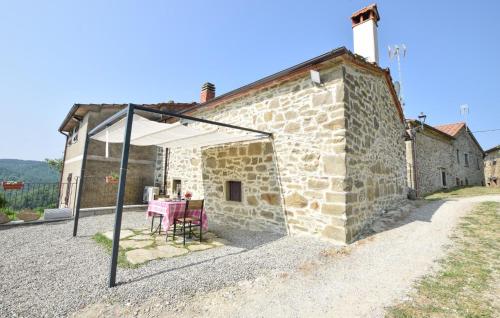 a table and chairs under a tent outside of a building at 1 Bedroom Stunning Home In Subbiano in Subbiano