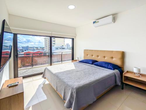 a bedroom with a bed and a large window at Alto Busch1d 4 in El Pary