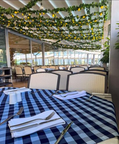 a table with a blue and white checkered table cloth at Astoria Hotel All Inclusive- Free parking, Private Beach & Beach Club in Golden Sands