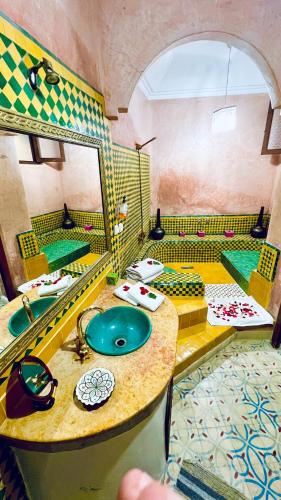 a bathroom with two sinks and a mirror at Riad Alida in Marrakesh