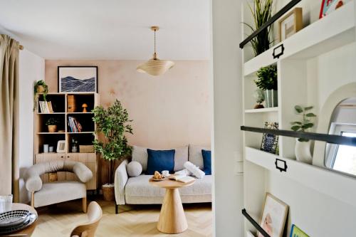 a living room with a couch and a table at Apartamenty In Hygge Jastrzębia Góra in Jastrzębia Góra