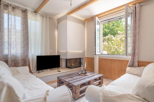 a living room with a couch and a tv at Stathis Home in Exanthia