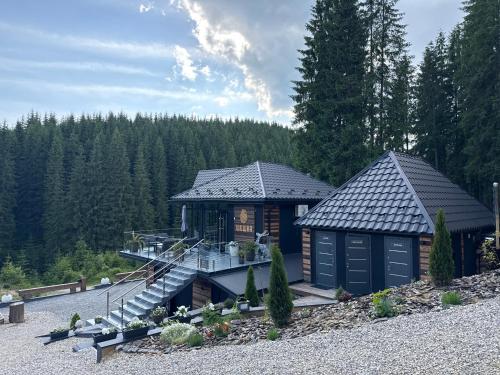 a log cabin with a staircase leading to a house at Шишка in Bukovel