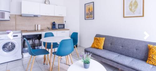 un salon avec un canapé et une table et une cuisine dans l'établissement Duplex tout confort, à Marpent