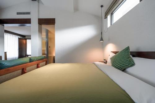 a bedroom with a large bed and a window at 大理沙溪云喜七月精品客栈 Shaxi Ancient Town Yunxi Qiyue Guesthouse in Jianchuan