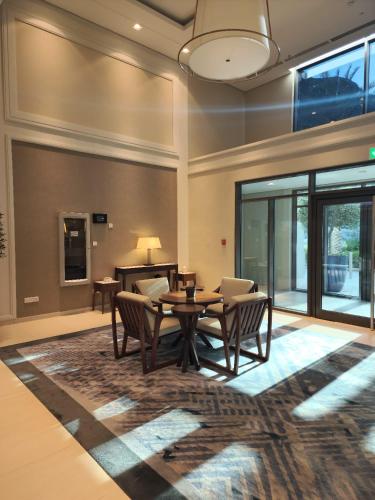 a dining room with a table and chairs on a rug at Ocean View Address Fujairah Beach Resort