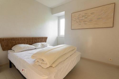 a bedroom with a bed with two pillows on it at Appartement avec parking La Flocellière in La Flocellière