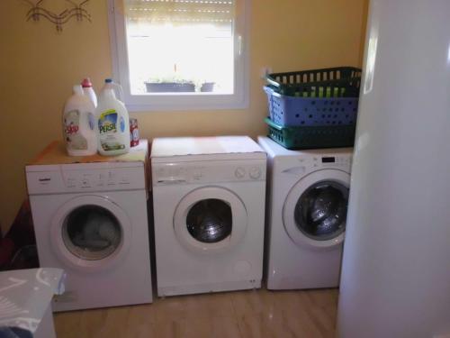 a laundry room with two washing machines and a window at Studio à Campagnac in Campagnac