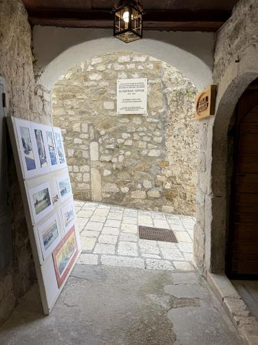 an entrance to a stone building with an archway at Studio Appartment & Rooms Old Town in Rab