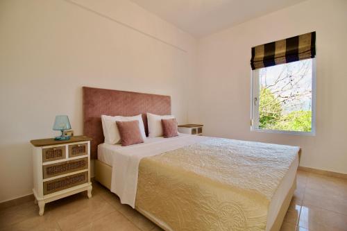 a bedroom with a large bed and a window at Archontariki Luxury suites collection in Lakithra village in Lakithra