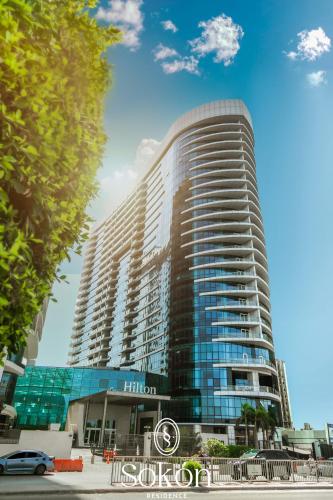 a tall building with a car parked in front of it at Sokon Residence Partial Nile view at Maadi in Cairo