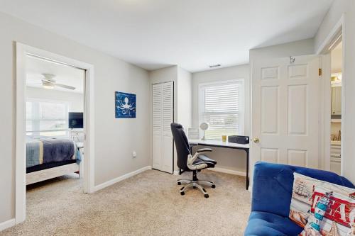 a bedroom with a desk and a chair and a bed at The Canal House --- 30131 New Castle Rd in Dagsboro