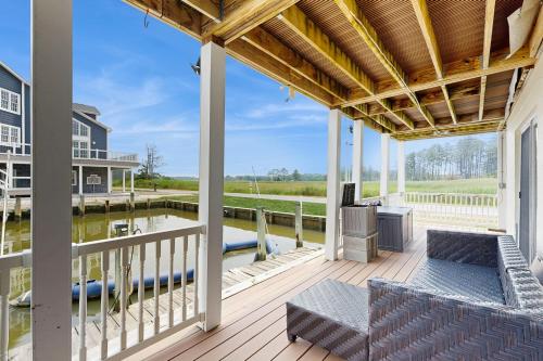 a porch with two chairs and a television on it at The Canal House --- 30131 New Castle Rd in Dagsboro
