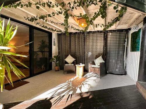 an outdoor patio with plants and a ceiling at Tranquil Balinese Retreat in a resort style oasis in Gold Coast