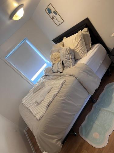 a bed in a room with a glass wall at Modern Sweet Home in Roberval