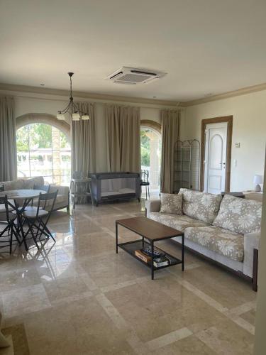 a living room with a couch and a table at Nostrana Village Apartments in Koskinou