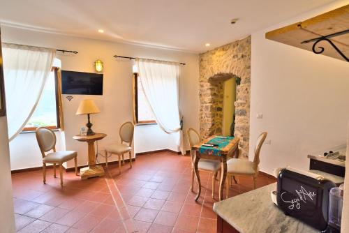 a living room with a table and chairs at Il Saracino boutique suites in Capraia