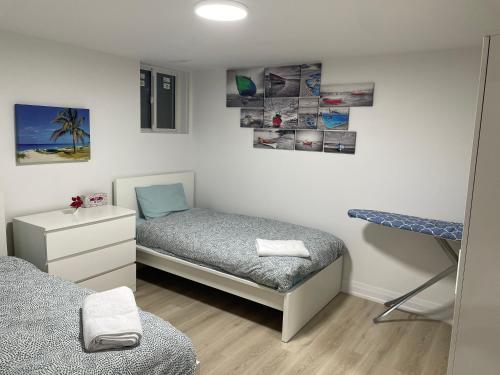 a bedroom with two twin beds and a desk at Executive Apartment - 2BDR Parking Self-check in - Walkout basement Lower Unit in Mississauga
