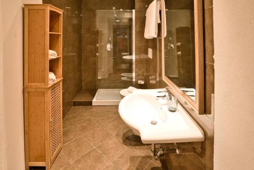 a bathroom with a sink and a shower at Il Saracino boutique suites in Capraia