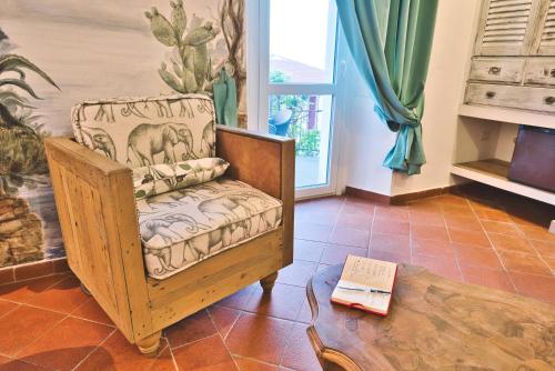 a room with a chair and a table and a coffee table at Il Saracino boutique suites in Capraia