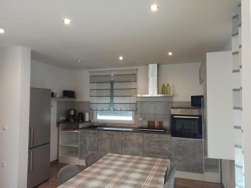 a kitchen with a table and a kitchen with a stove at Dream Days , House in Stüde