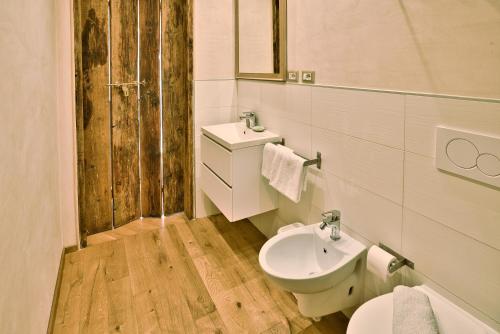 a bathroom with a toilet and a sink at Il Saracino boutique suites in Capraia