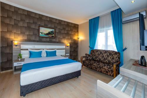 a hotel room with a bed and a couch at Nil Hotel İstanbul City Center in Istanbul