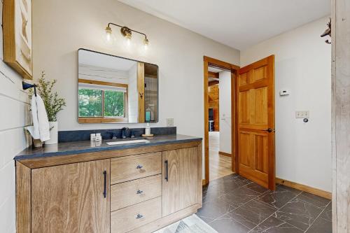 a bathroom with a sink and a mirror at The Lodge in Madison