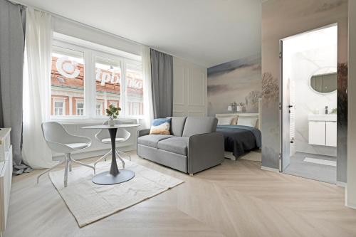 a bedroom with a bed and a couch and a table at Z-One City Center Luxury Apartments in Zagreb