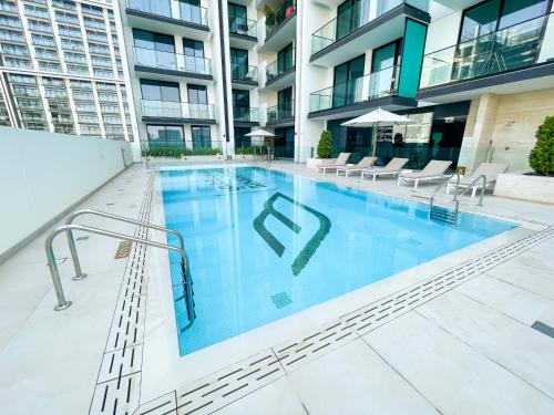 a large swimming pool in an apartment building at 1bhk brand new in JVC Binghatti Lavender in Dubai