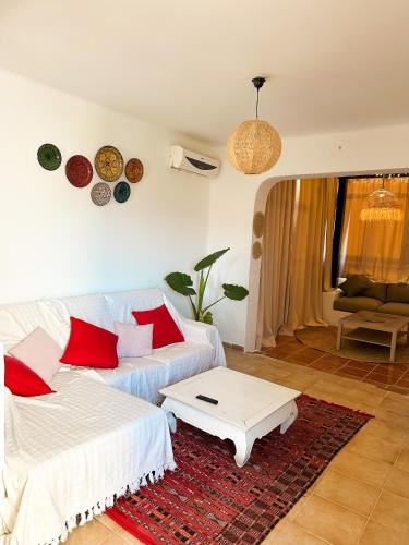 a living room with a couch and a coffee table at Alcudia Smir Complex piedras del Mar in Fnidek