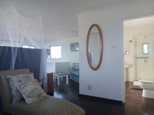 a living room with a mirror and a couch at Beach On High in Ramsgate