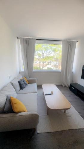 a living room with a couch and a coffee table at Nilly apartment Richmond Close Birmingham b20 in Birmingham