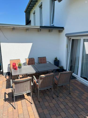 a patio with a table and chairs on a patio at Ferienwohnung Hügel Blick in Brücken