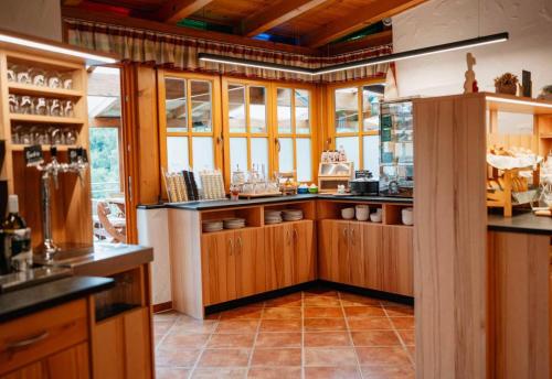 a kitchen with wooden cabinets and a counter top at Gästezimmer Steiner in Gamlitz