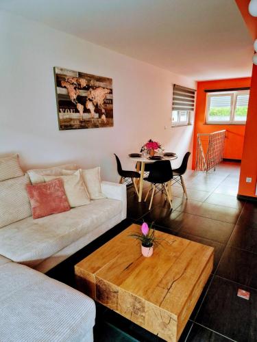 a living room with a couch and a table at Stay atLinda's - Calm & peaceful in Eischen