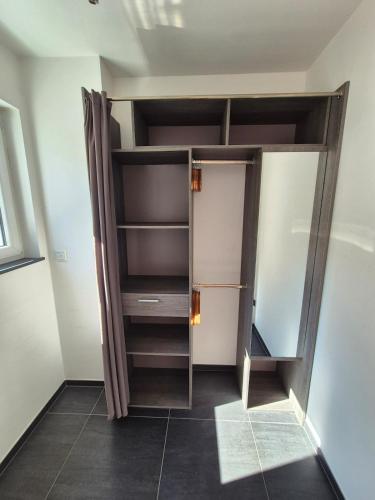 a walk in closet with a glass door and a mirror at Stay atLinda's - Calm & peaceful in Eischen