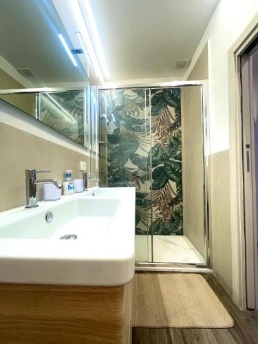 a bathroom with a sink and a shower at Casa DeA in Giardini Naxos